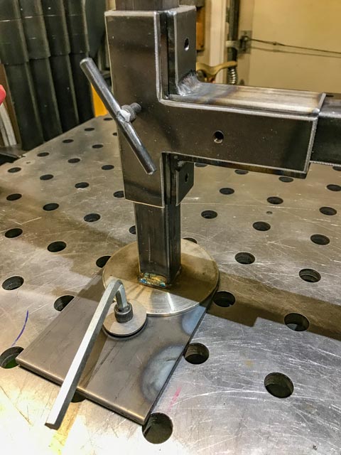 Rather that tacking on nuts, 1/4&quot; plates, tapped holes where used, to adjust the arm. The stainless round plate is used to keep the upright plumb and a place to lock the rotation.