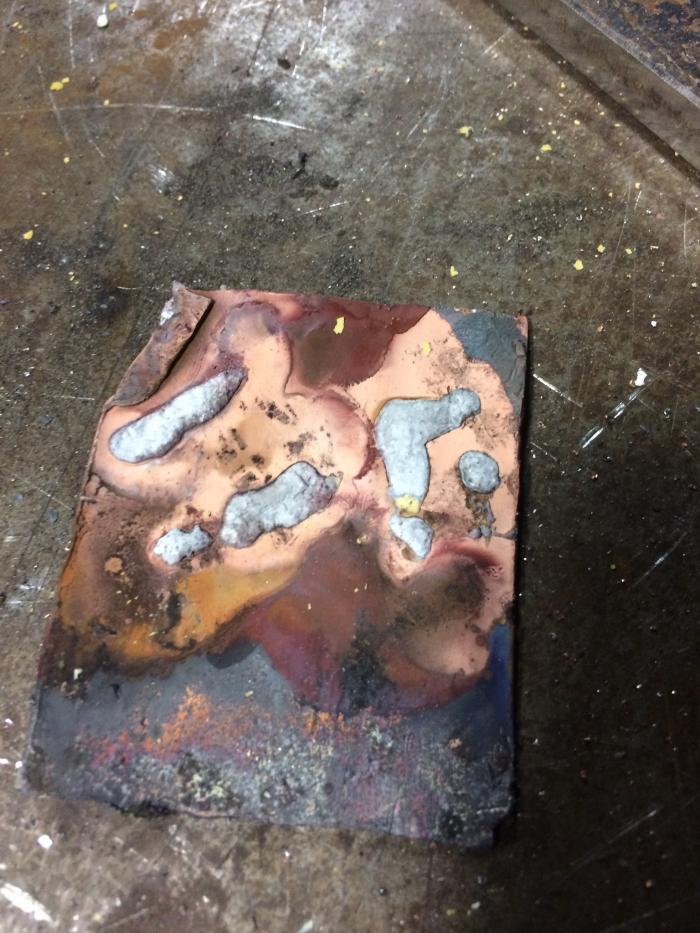 On a piece of old copper pipe hammered flat