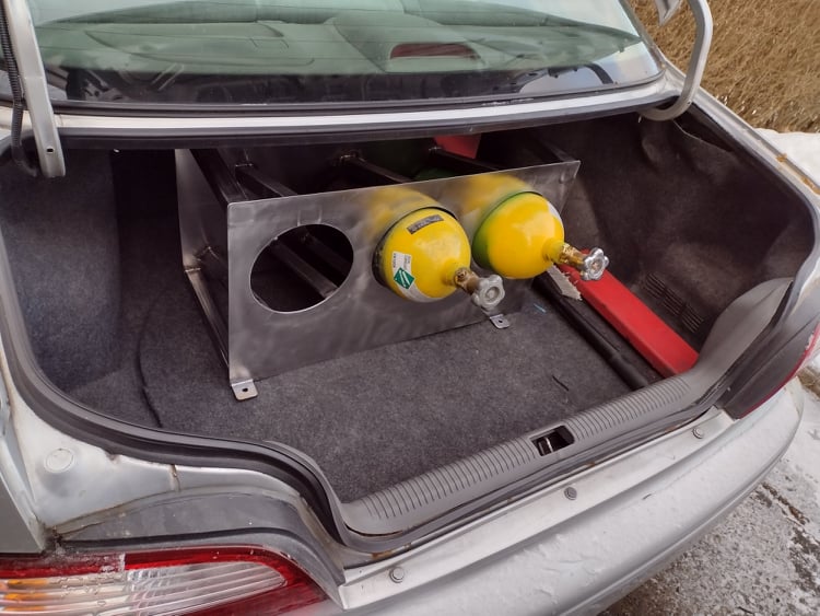 and my truck ended up dying on me and in the shop for a few days, but I needed to refill the bottles.. and check it out, it fit perfectly with room to spare in the wife's little 626! (that trunk is surprisingly big)